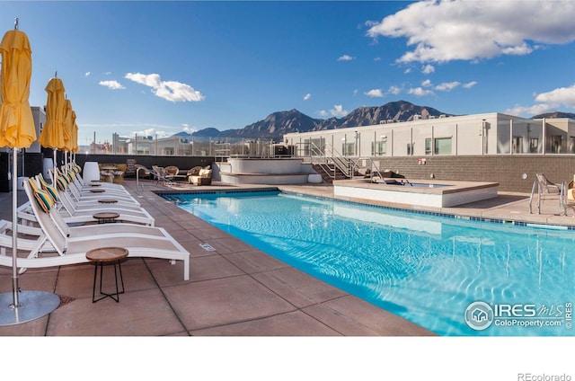 view of pool featuring a mountain view and a patio area