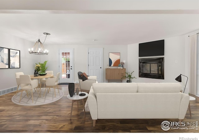 living room featuring a chandelier and dark hardwood / wood-style floors