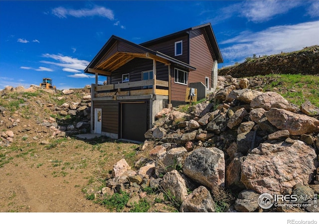 view of front of property with a garage and a balcony