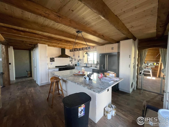 kitchen with dark hardwood / wood-style flooring, hanging light fixtures, white cabinetry, a center island, and high quality fridge