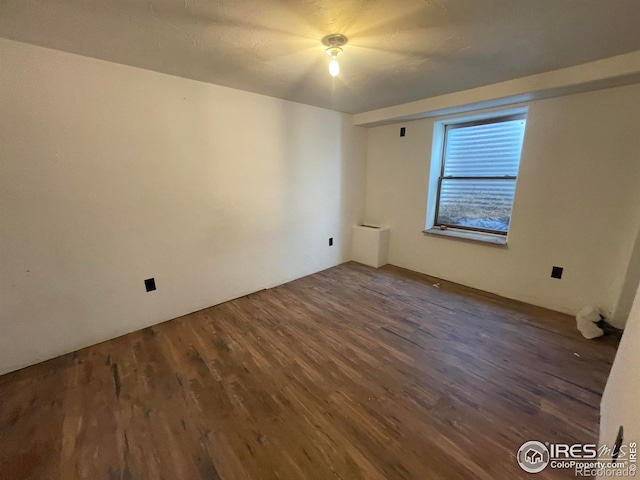 empty room featuring dark hardwood / wood-style flooring