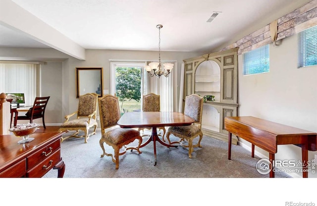 carpeted dining room with a notable chandelier and beamed ceiling