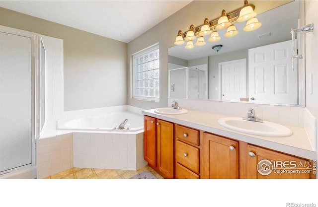 bathroom with vanity, independent shower and bath, and tile patterned flooring