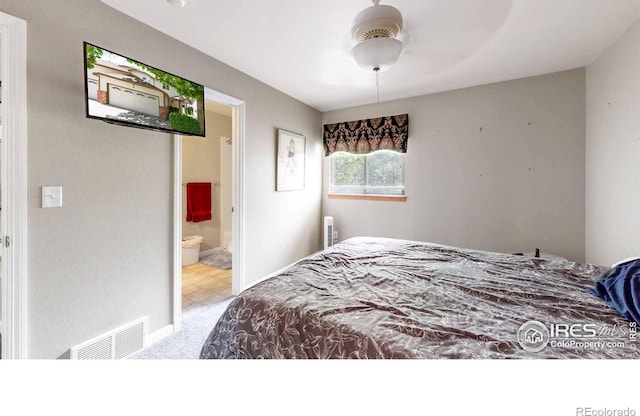 carpeted bedroom with connected bathroom and ceiling fan