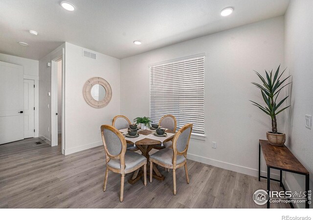 dining space featuring light wood-type flooring