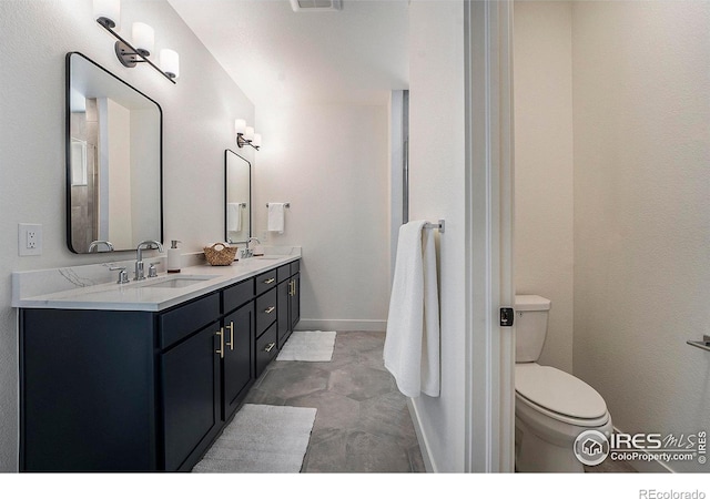 bathroom featuring tile patterned flooring, vanity, and toilet