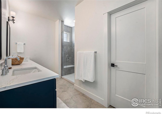 bathroom featuring tile patterned flooring, vanity, and a shower with shower door