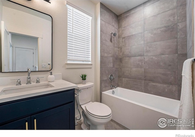 full bathroom with vanity, tiled shower / bath combo, toilet, and a wealth of natural light