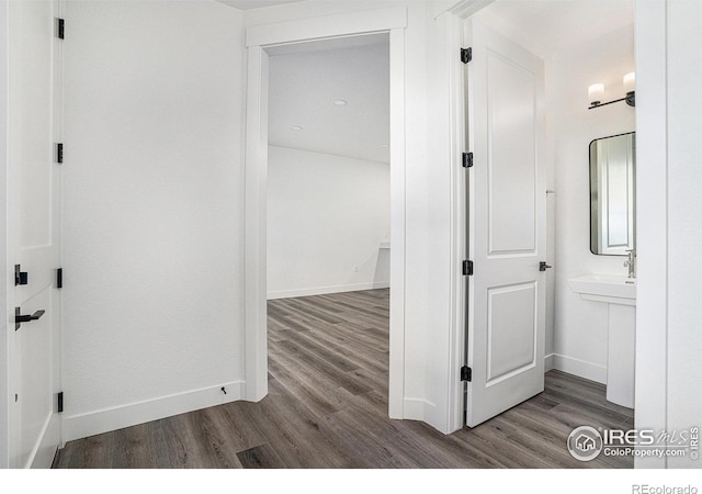 hallway with hardwood / wood-style flooring