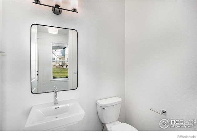 bathroom featuring toilet and sink