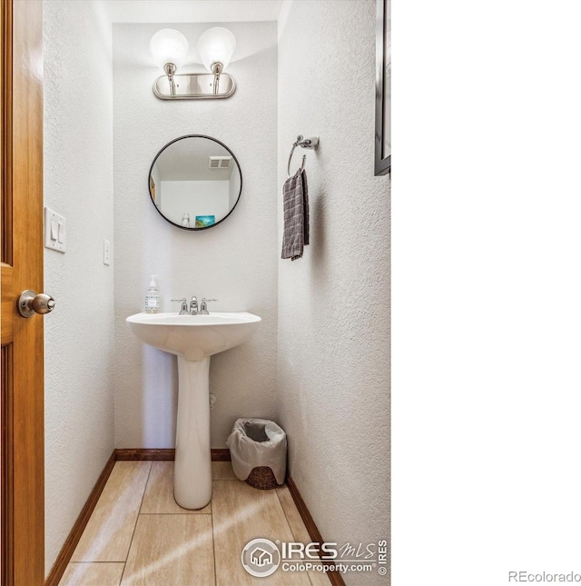 bathroom with tile patterned floors