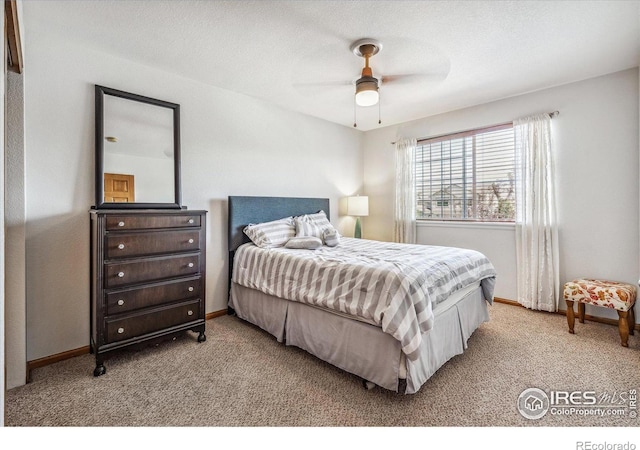 carpeted bedroom featuring a textured ceiling and ceiling fan