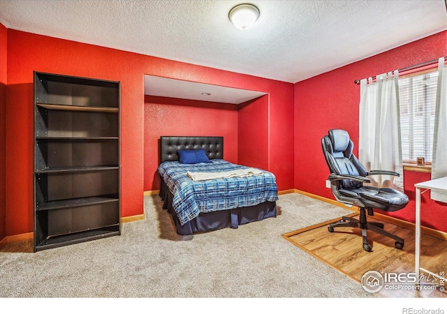 carpeted bedroom with a textured ceiling