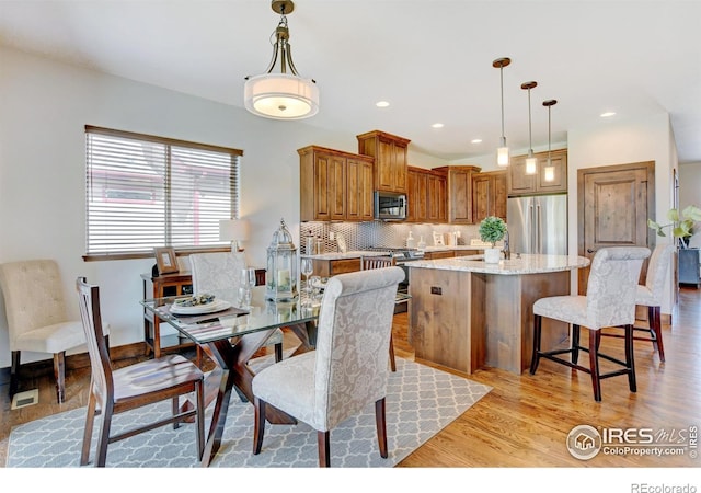 dining area featuring recessed lighting, visible vents, and light wood-style floors