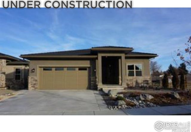 prairie-style home featuring an attached garage and driveway