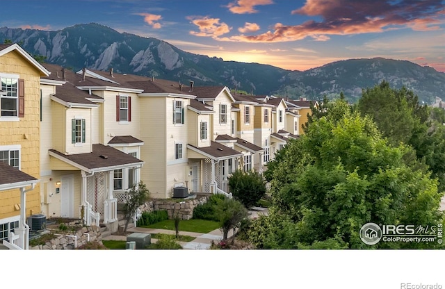 view of front of property featuring central air condition unit and a mountain view