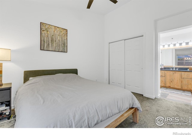 bedroom with light carpet, ensuite bath, a closet, and ceiling fan