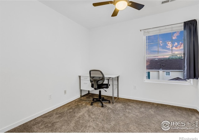 carpeted office space featuring ceiling fan