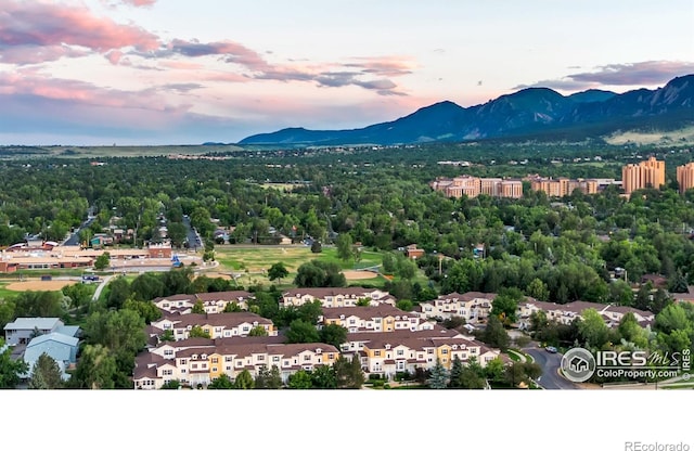 aerial view at dusk featuring a mountain view