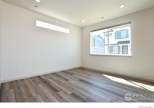 spare room with light hardwood / wood-style floors