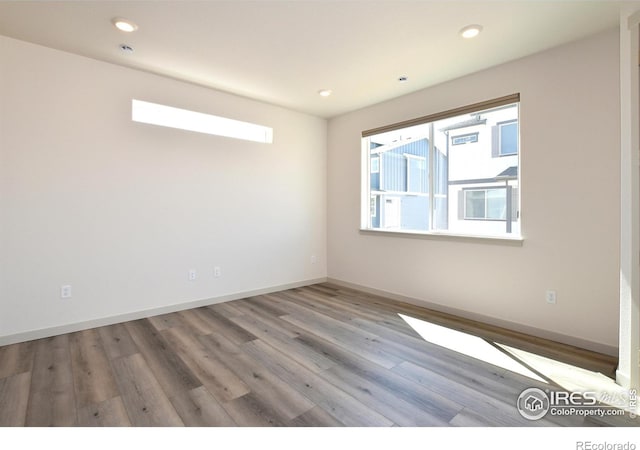 unfurnished room with light hardwood / wood-style flooring