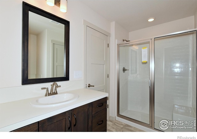 bathroom featuring vanity and an enclosed shower