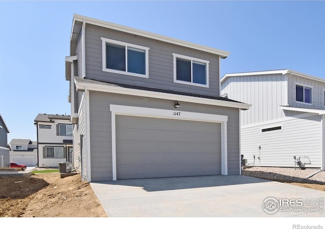 view of front of house with a garage and central AC unit