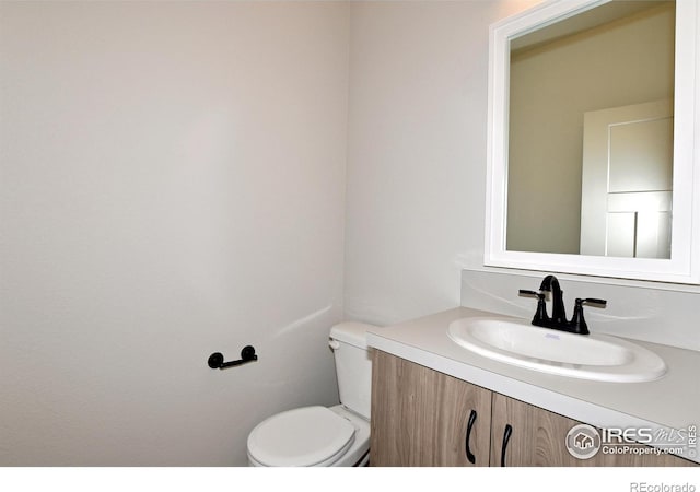 bathroom featuring vanity and toilet