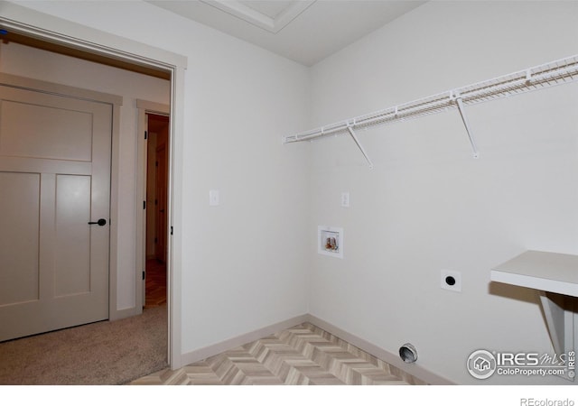 washroom with electric dryer hookup, washer hookup, and light carpet