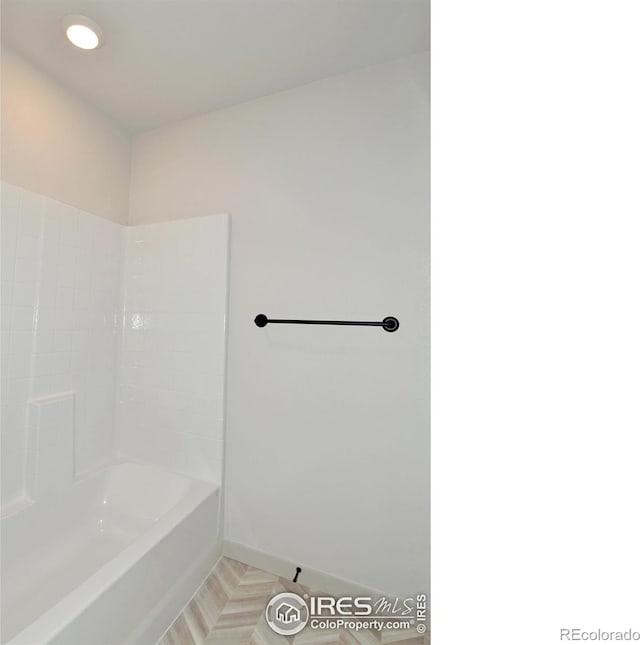 bathroom with shower / tub combination and parquet floors