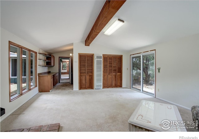 interior space with vaulted ceiling with beams