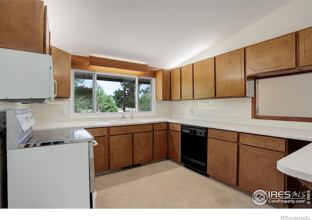 kitchen with white appliances, vaulted ceiling, sink, and decorative backsplash