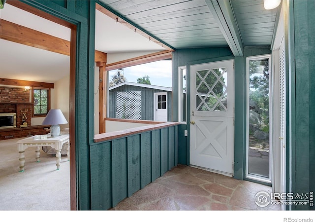 entrance to property with a stone fireplace