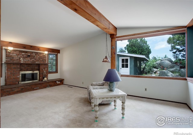 interior space featuring a brick fireplace, vaulted ceiling with beams, and carpet floors