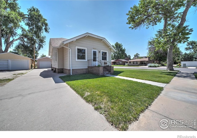 view of front of house with a front lawn, an outdoor structure, and a garage