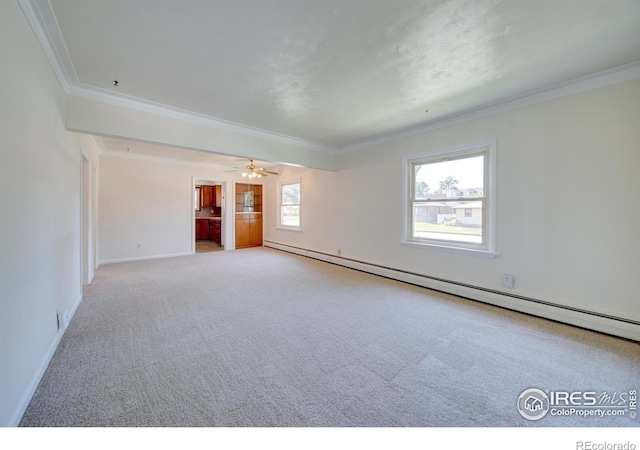 spare room featuring light carpet, a baseboard radiator, and ornamental molding