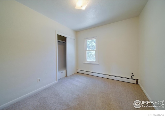 unfurnished bedroom with a closet, light carpet, and a baseboard radiator