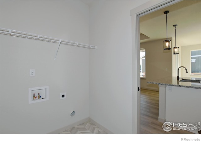 laundry area with washer hookup, sink, light hardwood / wood-style flooring, and electric dryer hookup