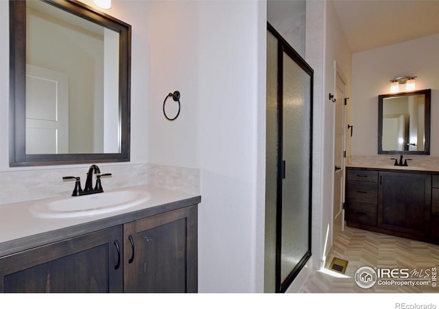 bathroom featuring an enclosed shower and vanity