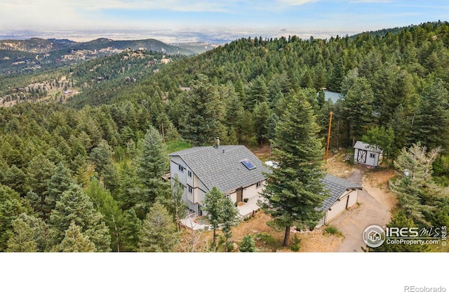 aerial view featuring a forest view and a mountain view