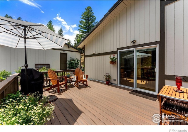 wooden terrace featuring area for grilling