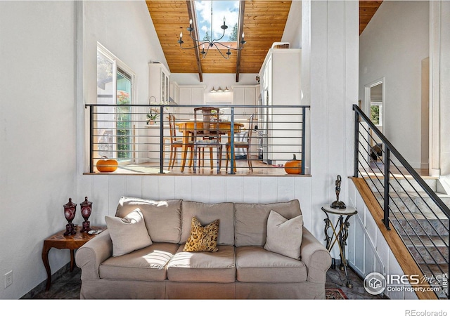 living room featuring stairs, vaulted ceiling, wood ceiling, and a notable chandelier