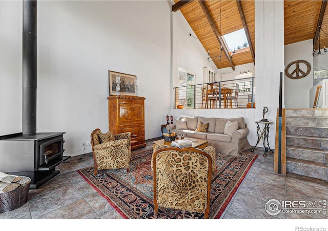 living room featuring high vaulted ceiling, wooden ceiling, stairs, beam ceiling, and a wood stove