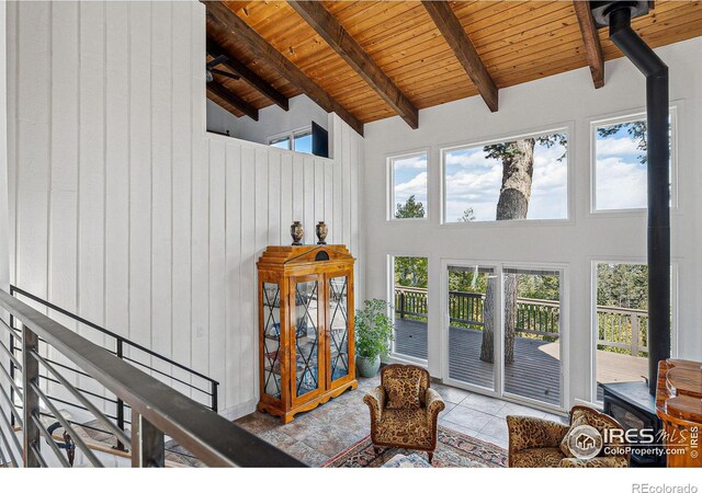 sitting room with wooden ceiling, high vaulted ceiling, and a wealth of natural light