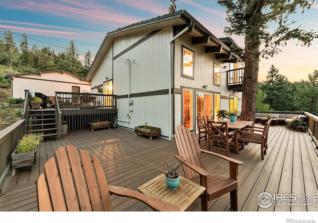 deck at dusk with outdoor dining area