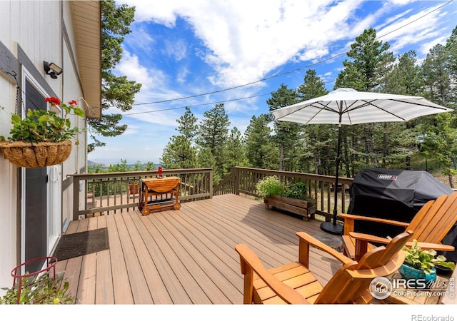 wooden terrace with a grill