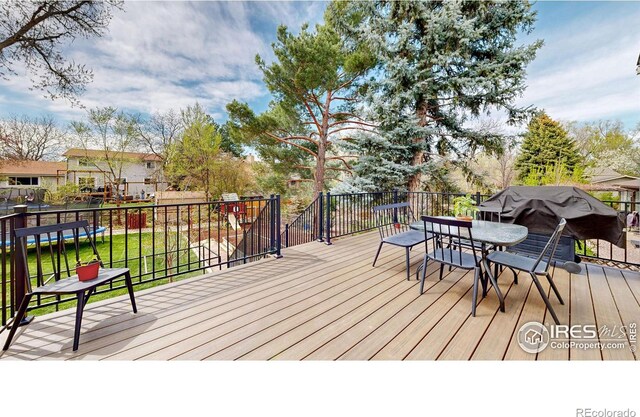 wooden terrace with a grill