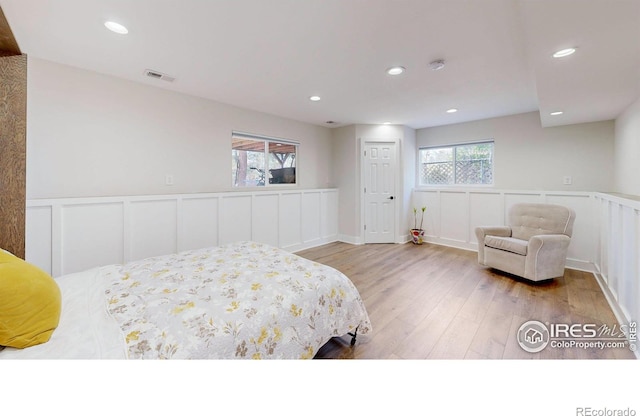 bedroom featuring light hardwood / wood-style floors and multiple windows