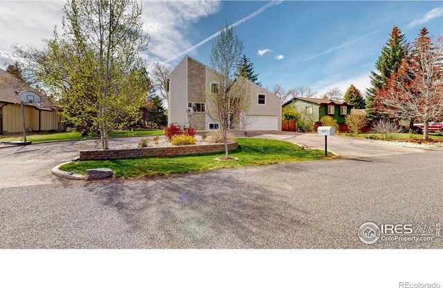 view of front of home featuring a garage and a front lawn