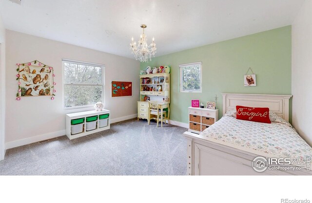 bedroom featuring light carpet and a chandelier